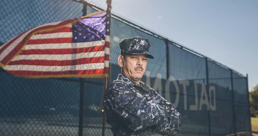 Veteran in front of United States flag